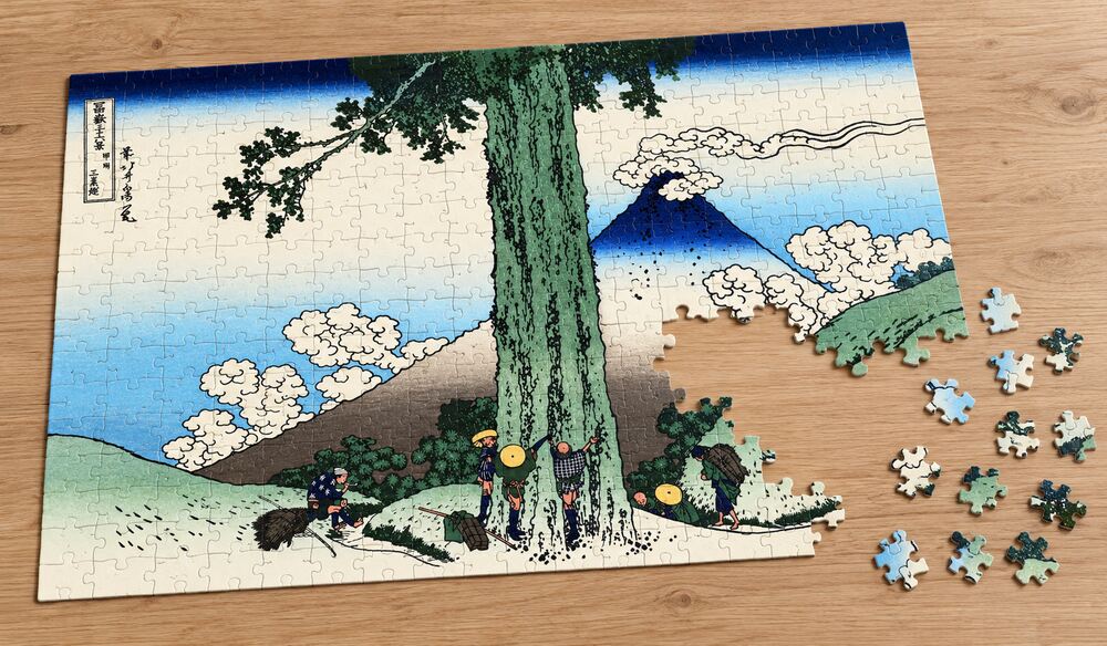 葛飾北斎「富嶽三十六景 甲州三嶌越」の組み立て途中のジグソーパズルを卓上に置いたイメージ