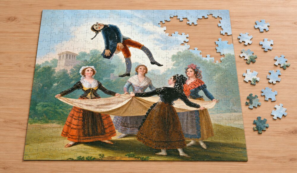 フランシスコ・デ・ゴヤ「わら人形遊び」を絵柄にした、組み立て途中のジグソーパズルのイメージ