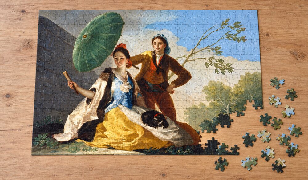 フランシスコ・デ・ゴヤ「日傘」を絵柄にした、組み立て途中のジグソーパズルのイメージ