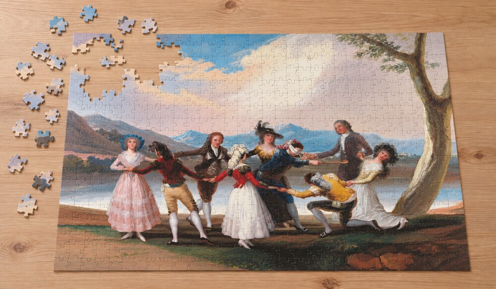 フランシスコ・デ・ゴヤ「目隠し遊び」を絵柄にした、組み立て途中のジグソーパズルのイメージ