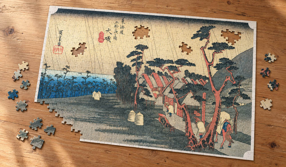 歌川広重「東海道五十三次 大礒宿 虎ヶ雨」を絵柄にした、組み立て途中のジグソーパズルのイメージ