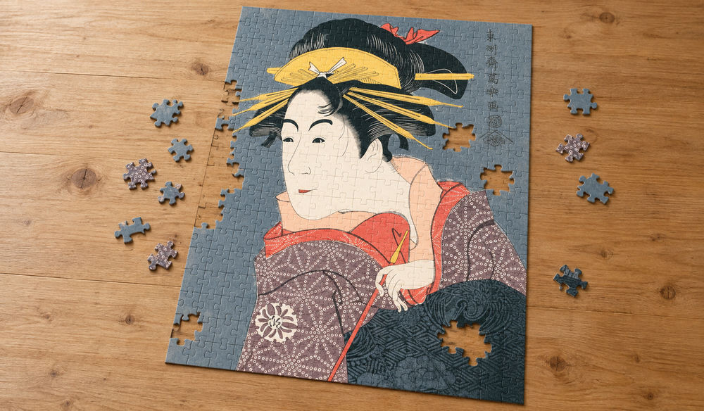 東洲斎写楽「松本米三郎のけはい坂少将実はしのぶ」を絵柄にした、組み立て途中のジグソーパズルのイメージ