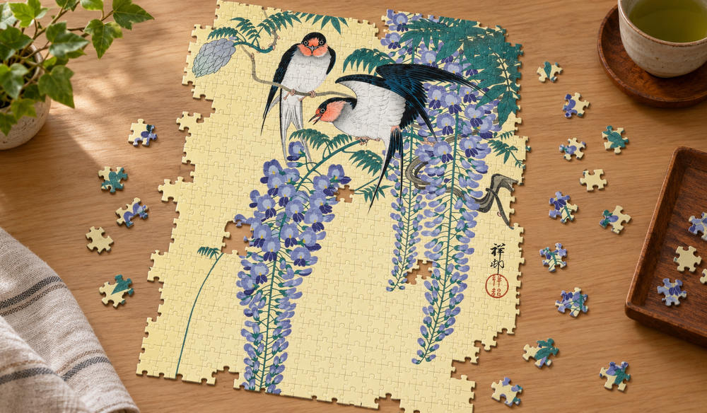 小原古邨「藤に燕」を絵柄にした、組み立て途中のジグソーパズルのイメージ