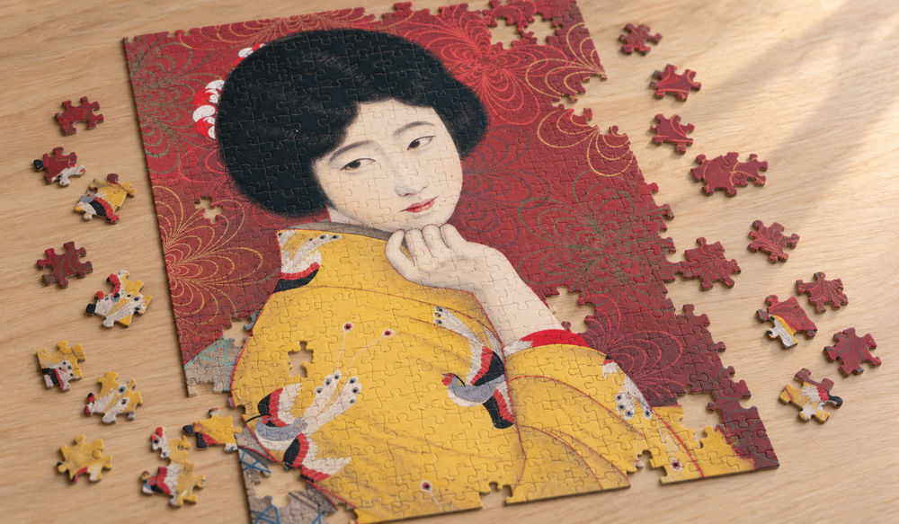北野恒富「足利本銘仙」を絵柄にした、組み立て途中のジグソーパズルのイメージ